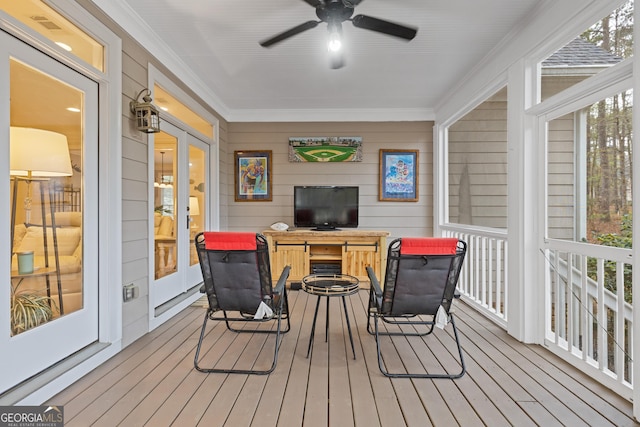 wooden terrace with a ceiling fan