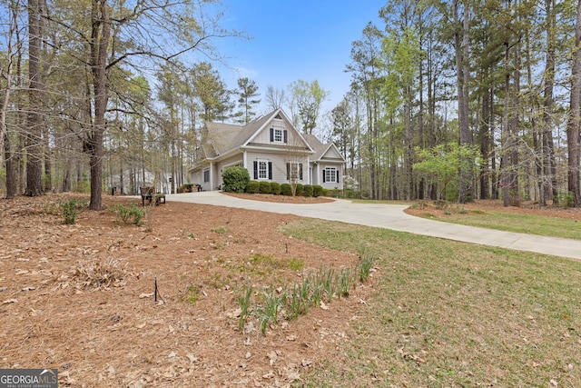 craftsman-style house featuring concrete driveway and a front lawn