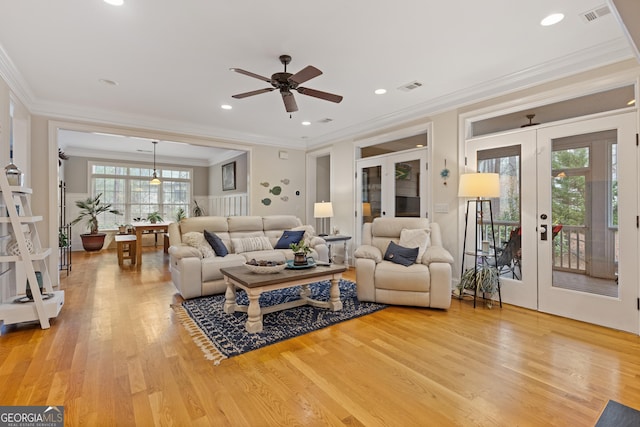 living area with french doors, crown molding, light wood-style floors, ceiling fan, and recessed lighting