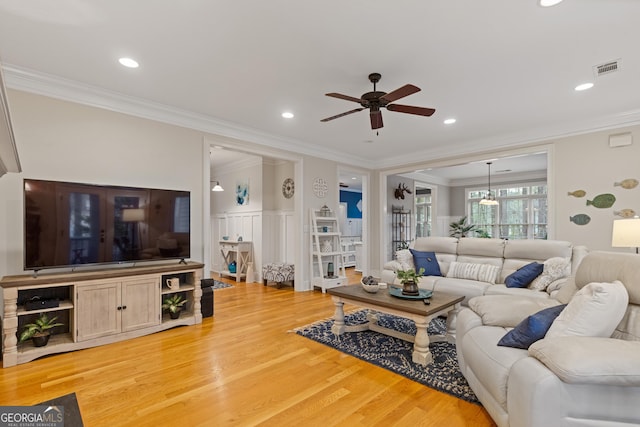 living area featuring ceiling fan, light wood-style flooring, ornamental molding, and recessed lighting