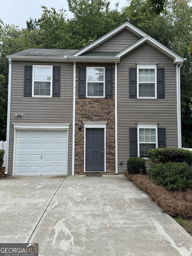 218 Osmanthus Way, Canton, GA 30114 - view of front of house with driveway, stone siding, and a garage