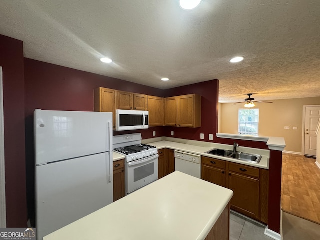 218 Osmanthus Way, Canton, GA 30114 - kitchen with white appliances, a peninsula, a sink, light countertops, and a textured ceiling