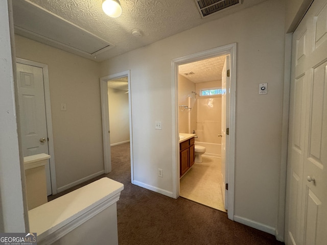 218 Osmanthus Way, Canton, GA 30114 - corridor with dark colored carpet, attic access, a textured ceiling, and baseboards