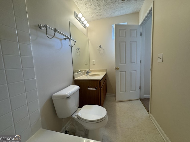 218 Osmanthus Way, Canton, GA 30114 - full bathroom featuring toilet, a textured ceiling, vanity, tile patterned floors, and baseboards