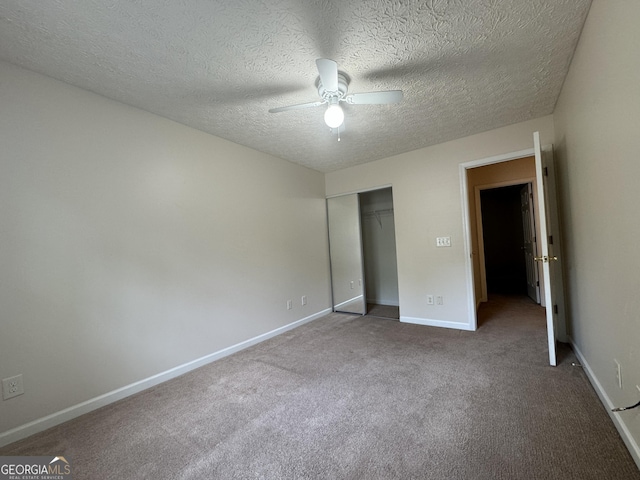 218 Osmanthus Way, Canton, GA 30114 - unfurnished bedroom featuring a closet, carpet, a textured ceiling, and a ceiling fan