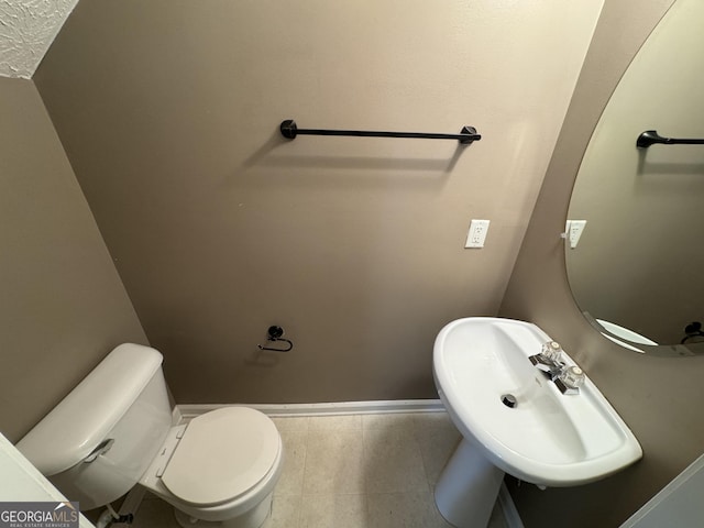 218 Osmanthus Way, Canton, GA 30114 - half bathroom featuring a sink, toilet, and baseboards
