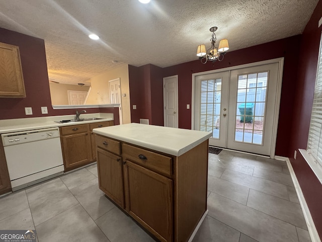 218 Osmanthus Way, Canton, GA 30114 - kitchen featuring white dishwasher, a sink, a textured ceiling, baseboards, and light countertops