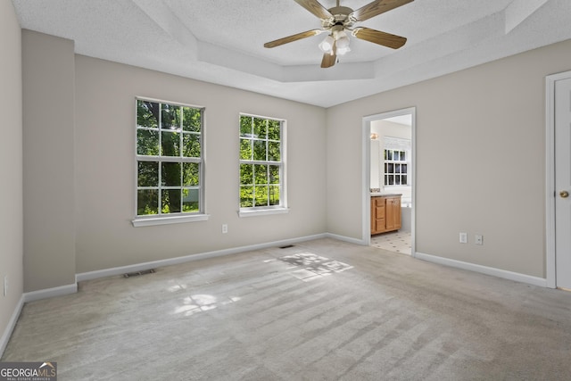 74 Rotunda Ct, Dallas, GA 30157 - unfurnished room with light colored carpet, a raised ceiling, baseboards, a ceiling fan, and a textured ceiling