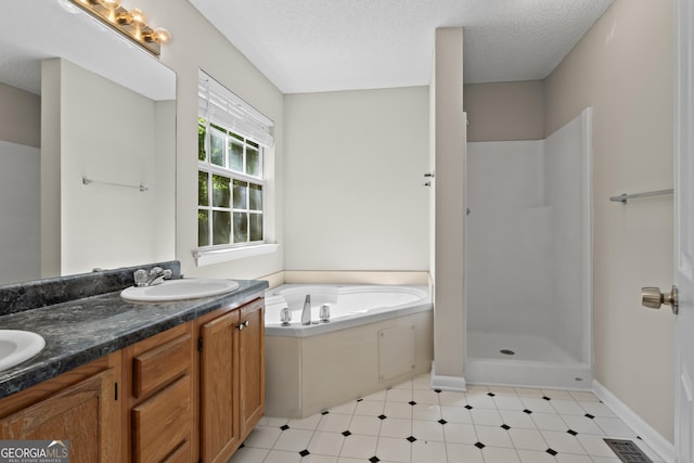 74 Rotunda Ct, Dallas, GA 30157 - full bath featuring a bath, double vanity, a shower, a textured ceiling, and baseboards
