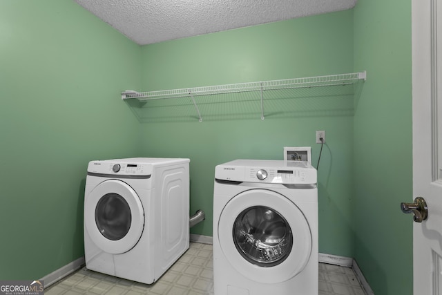 74 Rotunda Ct, Dallas, GA 30157 - laundry room featuring washing machine and clothes dryer, light floors, baseboards, and a textured ceiling