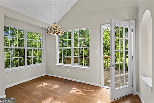 74 Rotunda Ct, Dallas, GA 30157 - unfurnished dining area with a chandelier, lofted ceiling, healthy amount of natural light, and wood finished floors