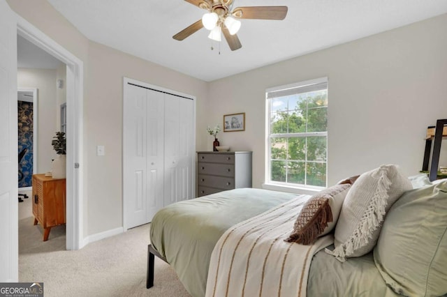 bedroom with carpet floors, a closet, baseboards, and a ceiling fan