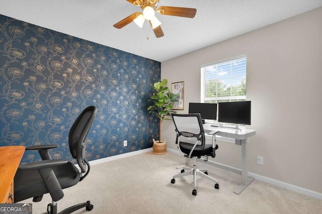 office area featuring ceiling fan, carpet floors, a textured ceiling, and baseboards