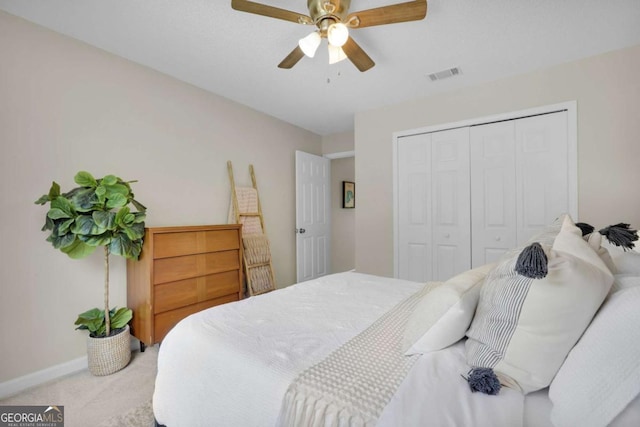 bedroom featuring carpet flooring, a closet, baseboards, and ceiling fan
