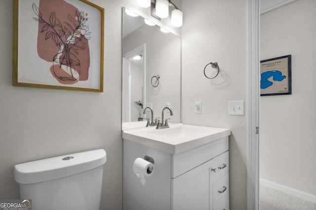 bathroom featuring toilet and vanity