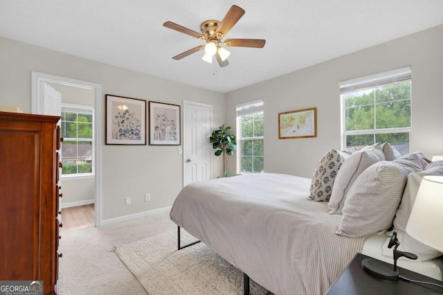 carpeted bedroom with baseboards, a closet, and a ceiling fan
