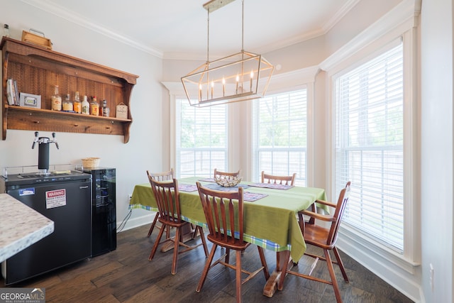 4043 Gramercy Dr, Valdosta, GA 31605 - dining space featuring a chandelier, ornamental molding, dark wood-style floors, and baseboards