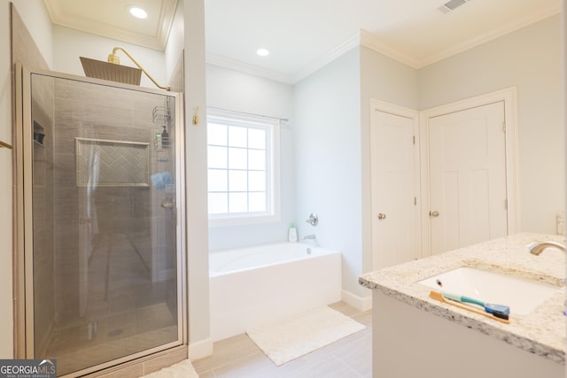 4043 Gramercy Dr, Valdosta, GA 31605 - bathroom featuring a stall shower, a bath, crown molding, double vanity, and baseboards