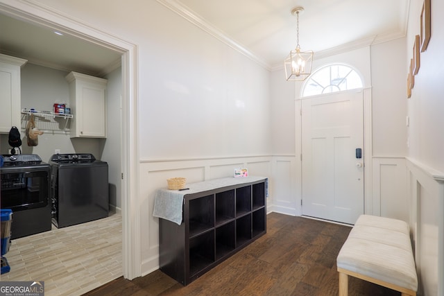 4043 Gramercy Dr, Valdosta, GA 31605 - entrance foyer with washing machine and clothes dryer, ornamental molding, a chandelier, dark wood-style floors, and wainscoting