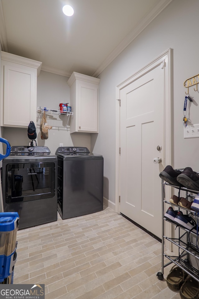 4043 Gramercy Dr, Valdosta, GA 31605 - washroom featuring separate washer and dryer, crown molding, cabinet space, baseboards, and light wood finished floors