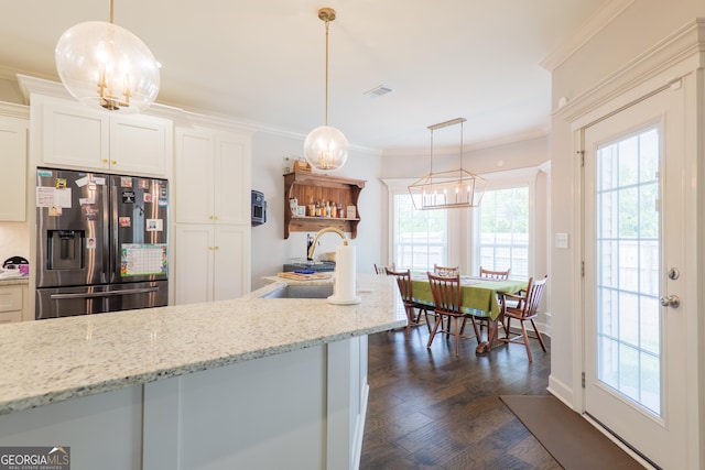 4043 Gramercy Dr, Valdosta, GA 31605 - kitchen featuring stainless steel fridge with ice dispenser, a sink, healthy amount of natural light, white cabinetry, and ornamental molding
