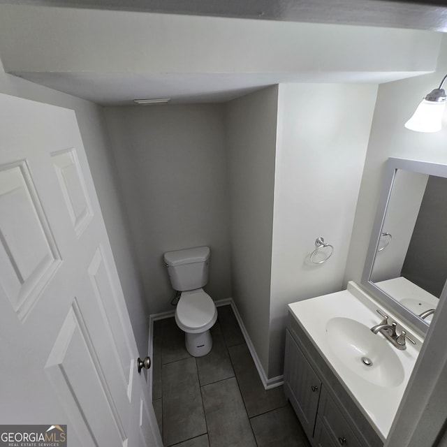590 Dot Dr, Atlanta, GA 30349 - half bath with tile patterned floors, toilet, vanity, and baseboards
