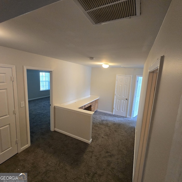 590 Dot Dr, Atlanta, GA 30349 - corridor featuring dark carpet and baseboards