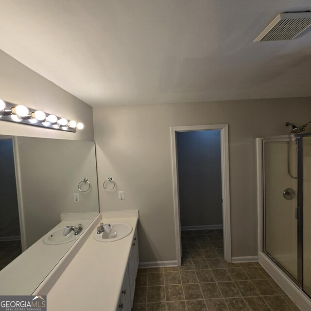 590 Dot Dr, Atlanta, GA 30349 - full bath with a stall shower, vanity, and baseboards