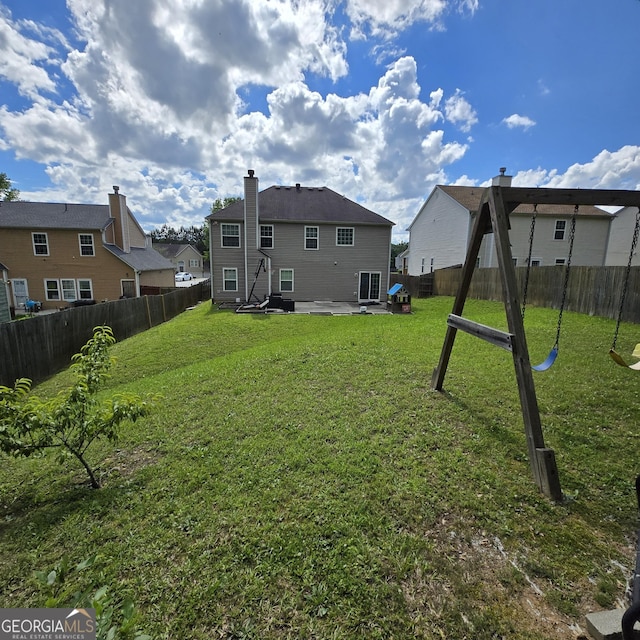 590 Dot Dr, Atlanta, GA 30349 - back of property with a patio and a residential view