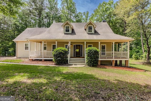 view of front of property with a porch, a front lawn, a chimney, and roof with shingles