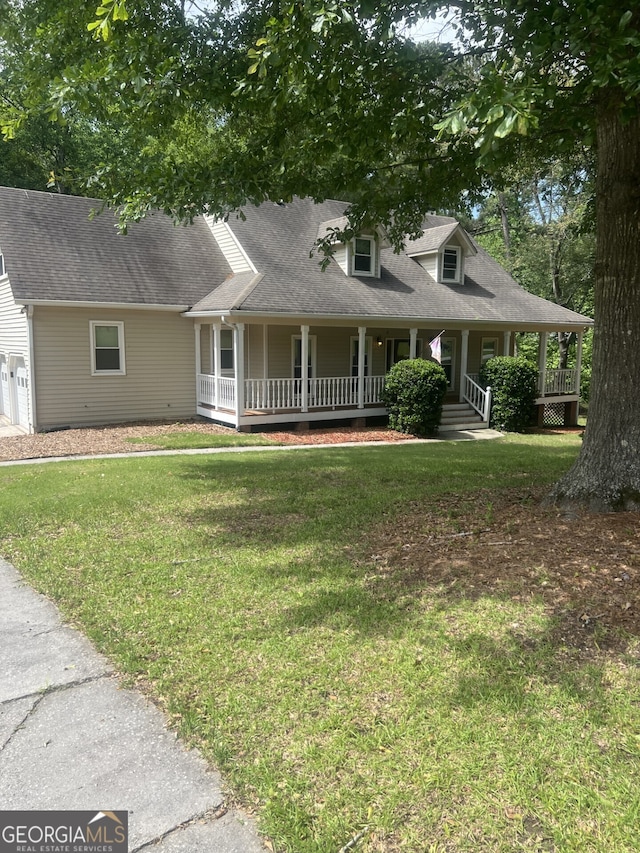 farmhouse-style home with a porch, a front yard, and a shingled roof