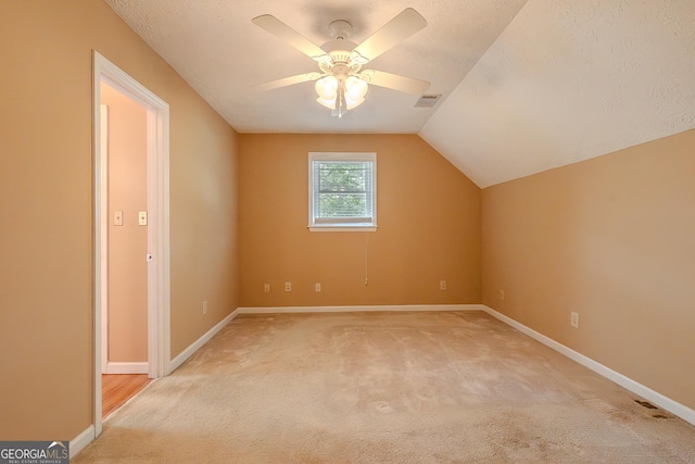 bonus room featuring light carpet, ceiling fan, baseboards, and lofted ceiling