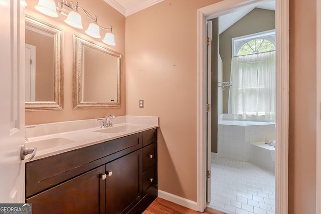 bathroom with double vanity, baseboards, a bath, crown molding, and vaulted ceiling