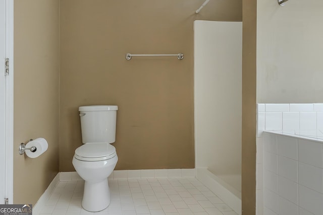 bathroom with toilet, a shower, and tile patterned floors