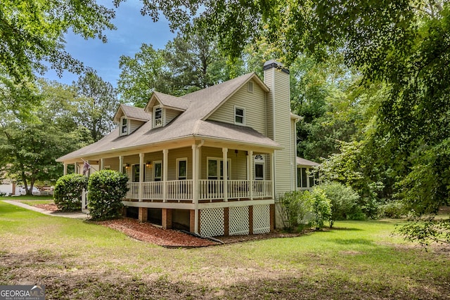 view of front of home with a porch, a front lawn, a chimney, and a shingled roof