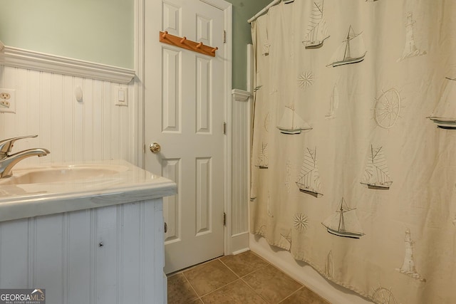 full bathroom with tile patterned flooring, vanity, and shower / tub combo