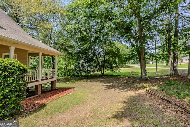 view of grassy yard featuring a deck