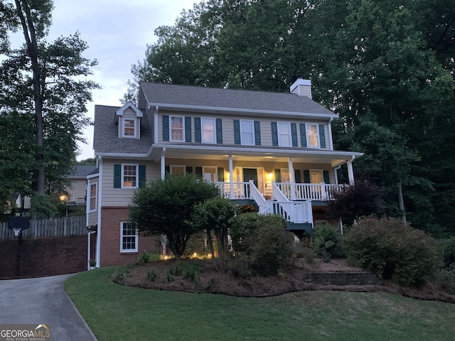 1935 Shrader Ct, Lawrenceville, GA 30044 - colonial inspired home featuring a porch, a chimney, and brick siding