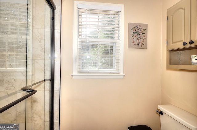 1935 Shrader Ct, Lawrenceville, GA 30044 - bathroom with toilet, plenty of natural light, and a tile shower