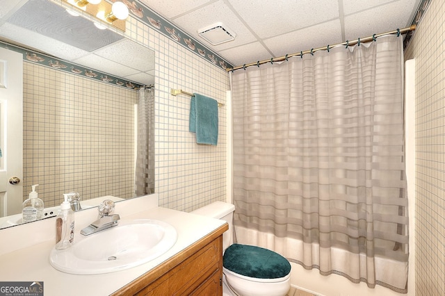 1935 Shrader Ct, Lawrenceville, GA 30044 - bathroom featuring a drop ceiling, toilet, vanity, and shower / bathtub combination with curtain