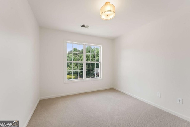 carpeted empty room with baseboards