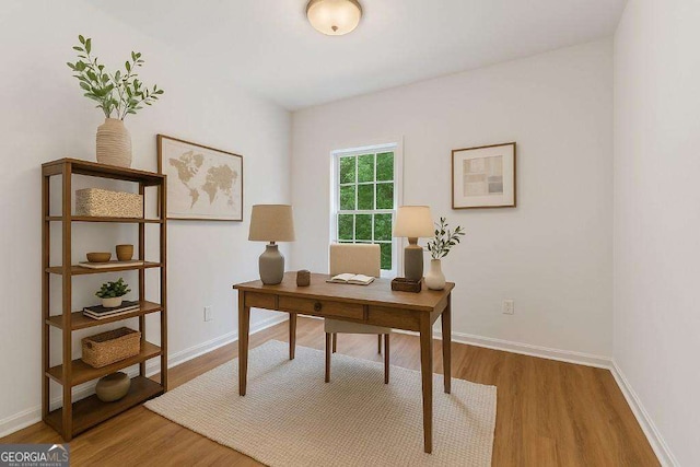office area with wood finished floors and baseboards