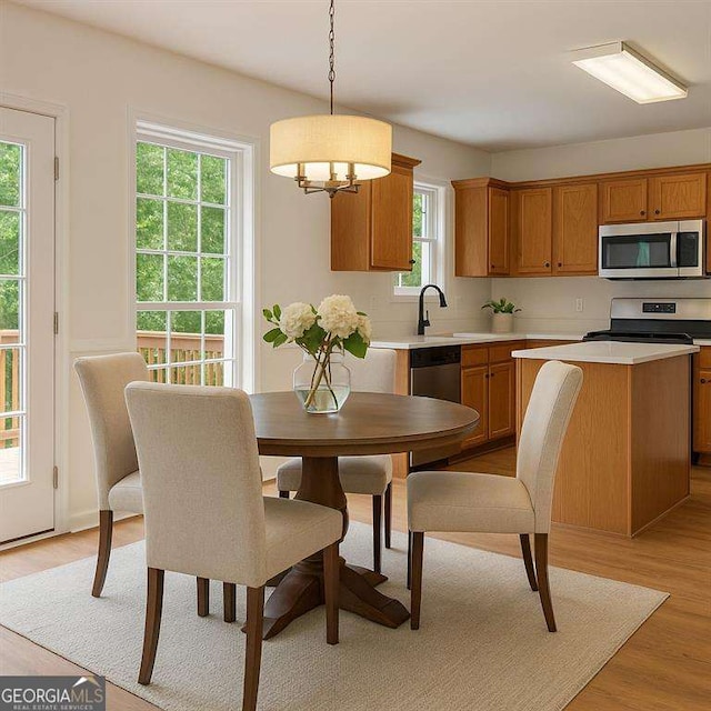 dining area featuring light wood-style floors and a chandelier