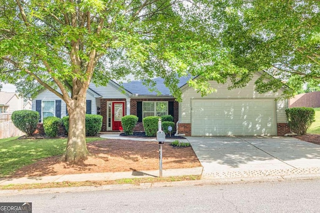 252 River Mist Cir, Jefferson, GA 30549 - view of front facade featuring brick siding, a garage, driveway, and fence