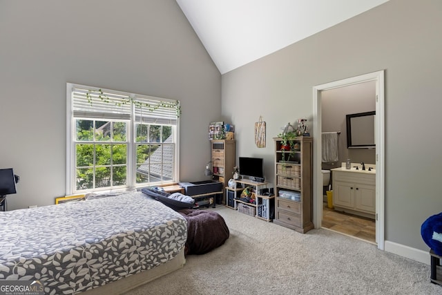 1029 Laurel Grove Cts, Suwanee, GA 30024 - carpeted bedroom featuring high vaulted ceiling, connected bathroom, a sink, and baseboards