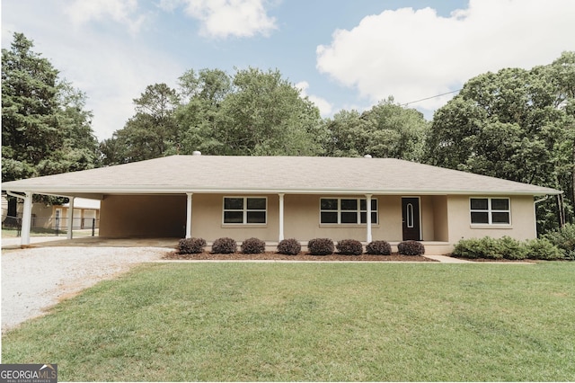 ranch-style house featuring driveway, a carport, a front lawn, and stucco siding