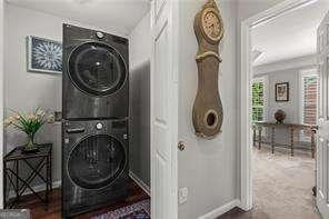 1667 Wehunt Pl SE Unit 11, Smyrna, GA 30082 - clothes washing area featuring estacked washer and dryer and baseboards