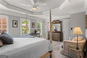 1667 Wehunt Pl SE Unit 11, Smyrna, GA 30082 - bedroom featuring a tray ceiling, crown molding, and ceiling fan