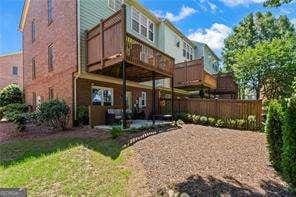 1667 Wehunt Pl SE Unit 11, Smyrna, GA 30082 - back of property with a deck, a patio area, and fence