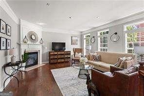1667 Wehunt Pl SE Unit 11, Smyrna, GA 30082 - living room with a fireplace, wood finished floors, and crown molding